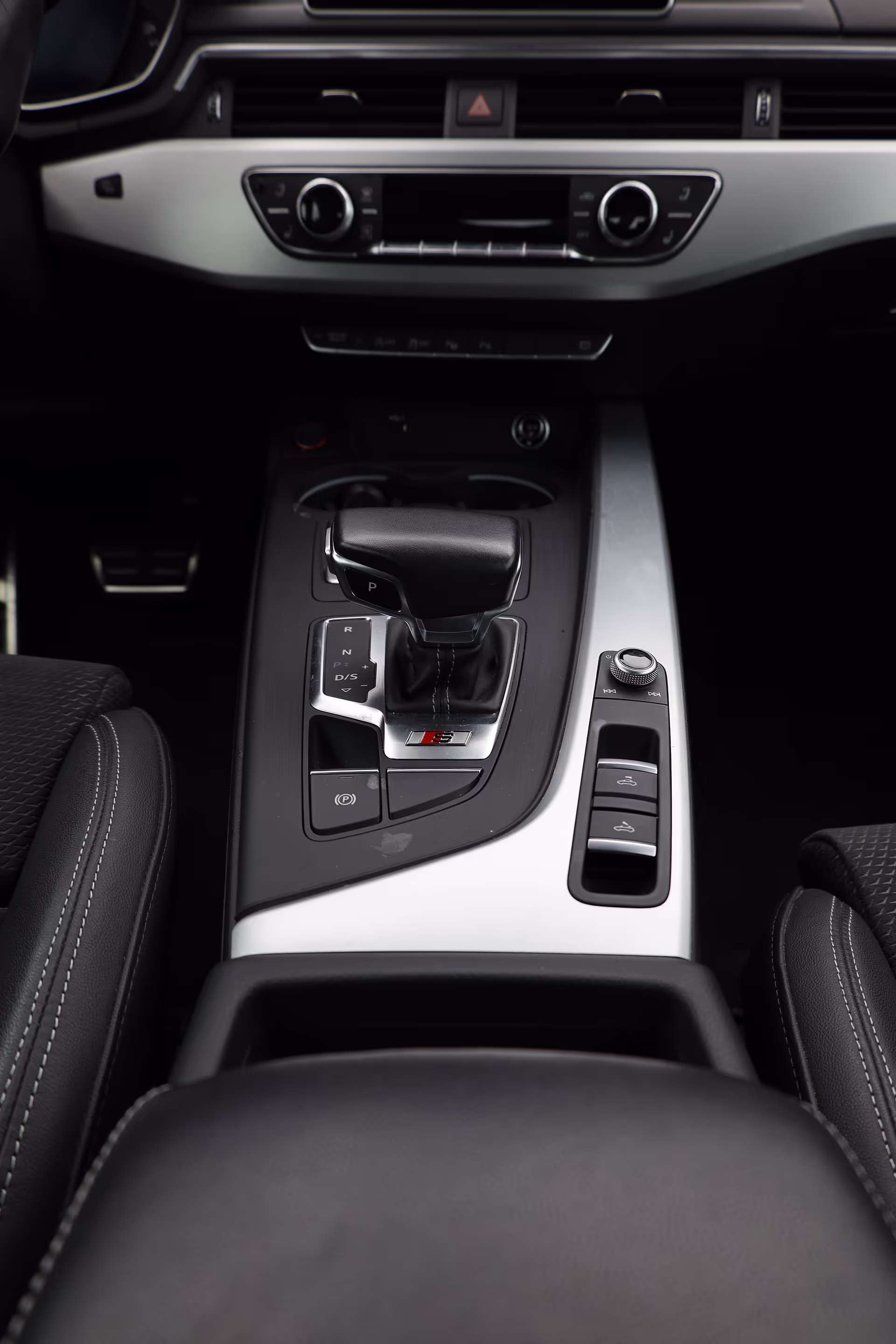 Photograph car interiors including gear shifts and center consoles with touch-screen iPhone camera control.